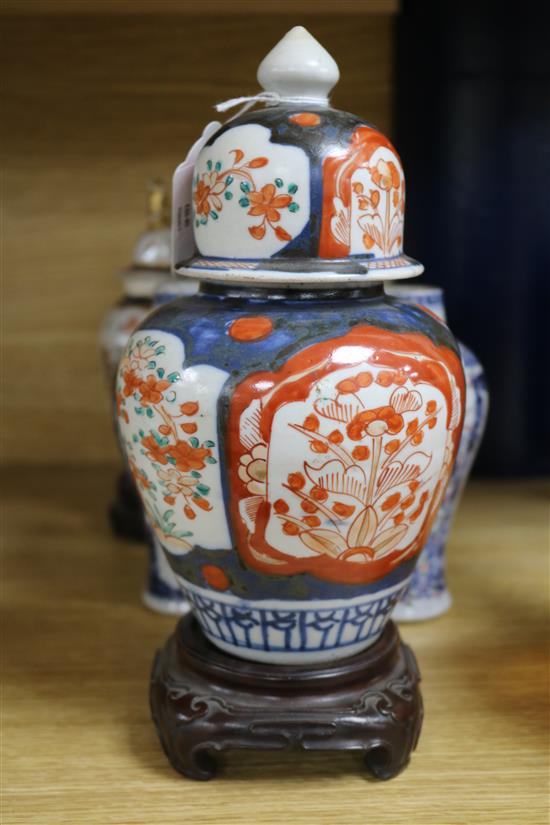 A pair of Chinese famille rose vases, a pair Samson vases and cover, and an Imari vase and cover smallest 15cm, tallest 22cm